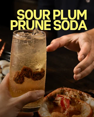 Sour plum prune soda served with ice at the dining table